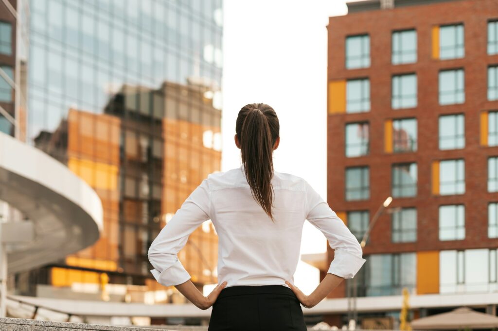 Rear view of businesswoman looking business buildings